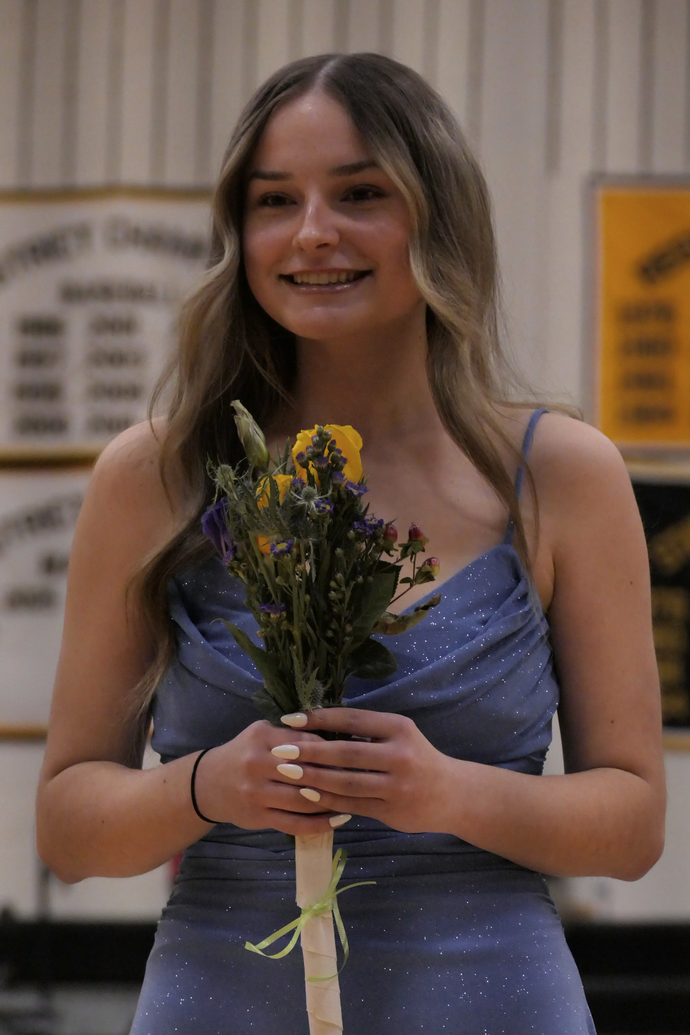 girl in a dress holding flowers